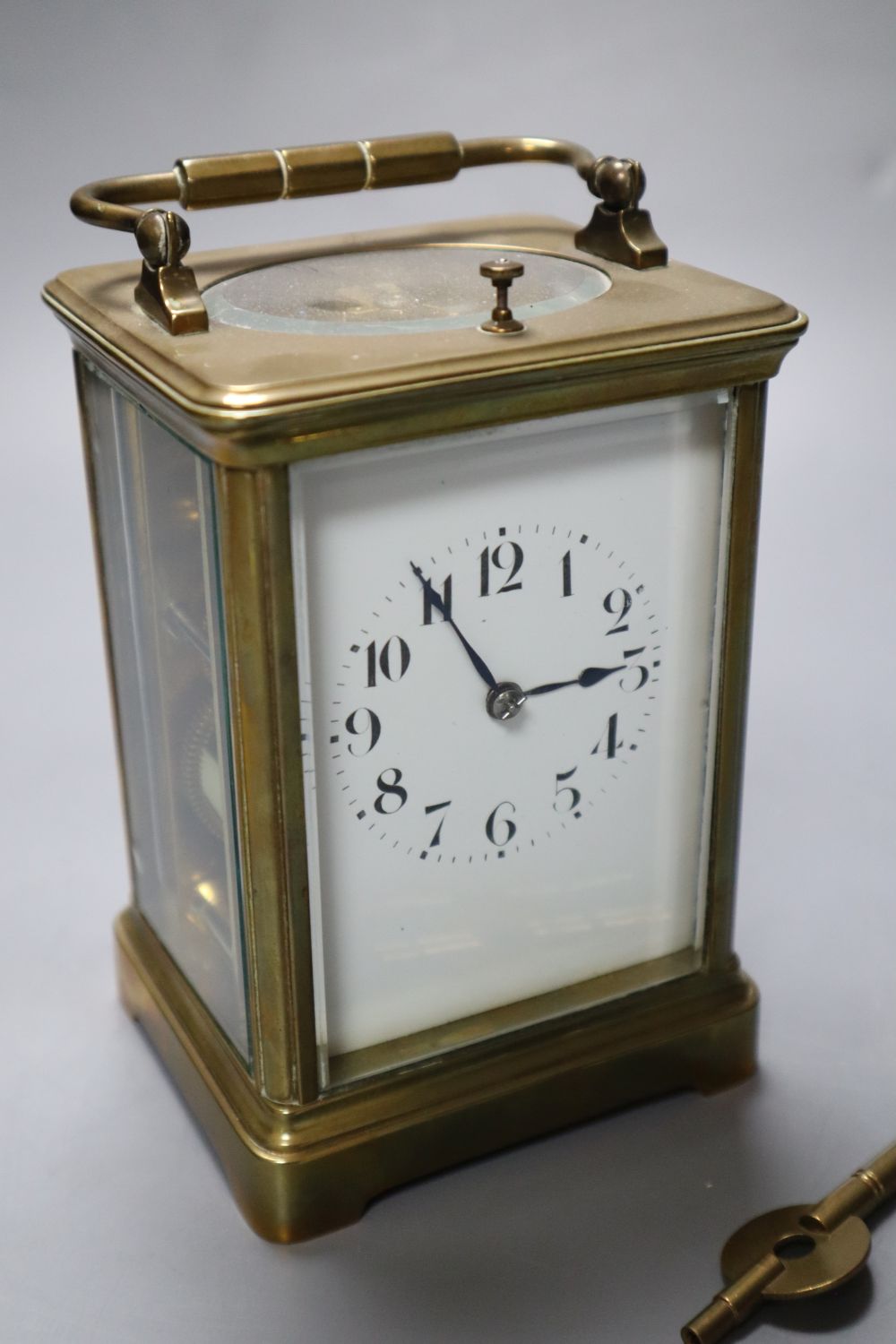 A French brass repeating carriage clock, enamelled dial, Obis case, height 18cm incl. handle